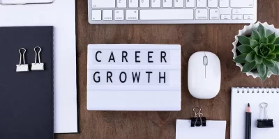 Career growth concept with office desk flat lay